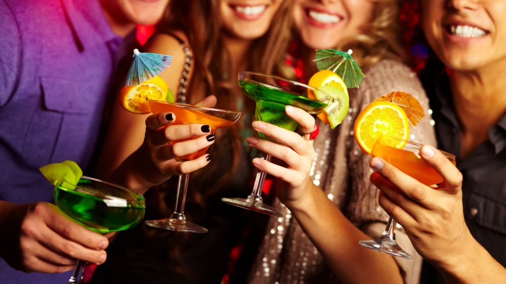 people dancing with cocktails